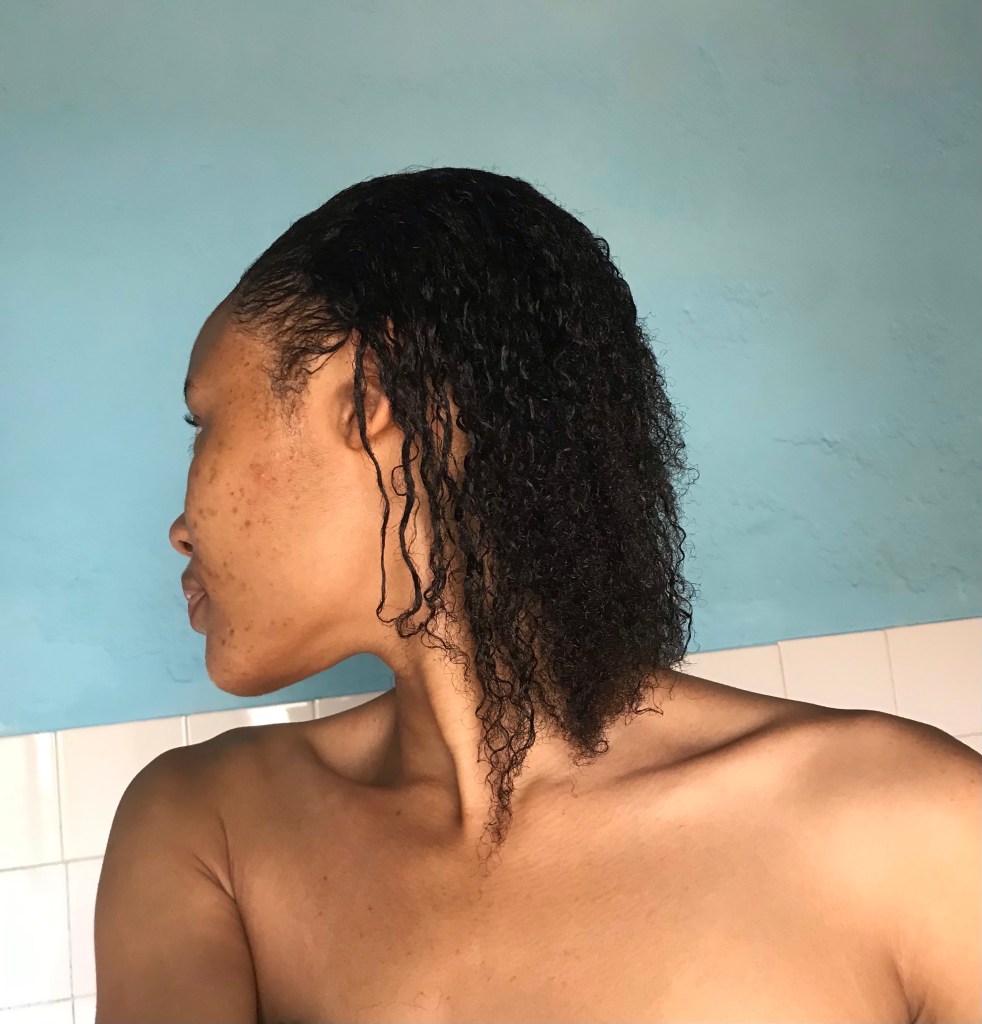 Mulher negra com o cabelo relaxado ou desfrisado